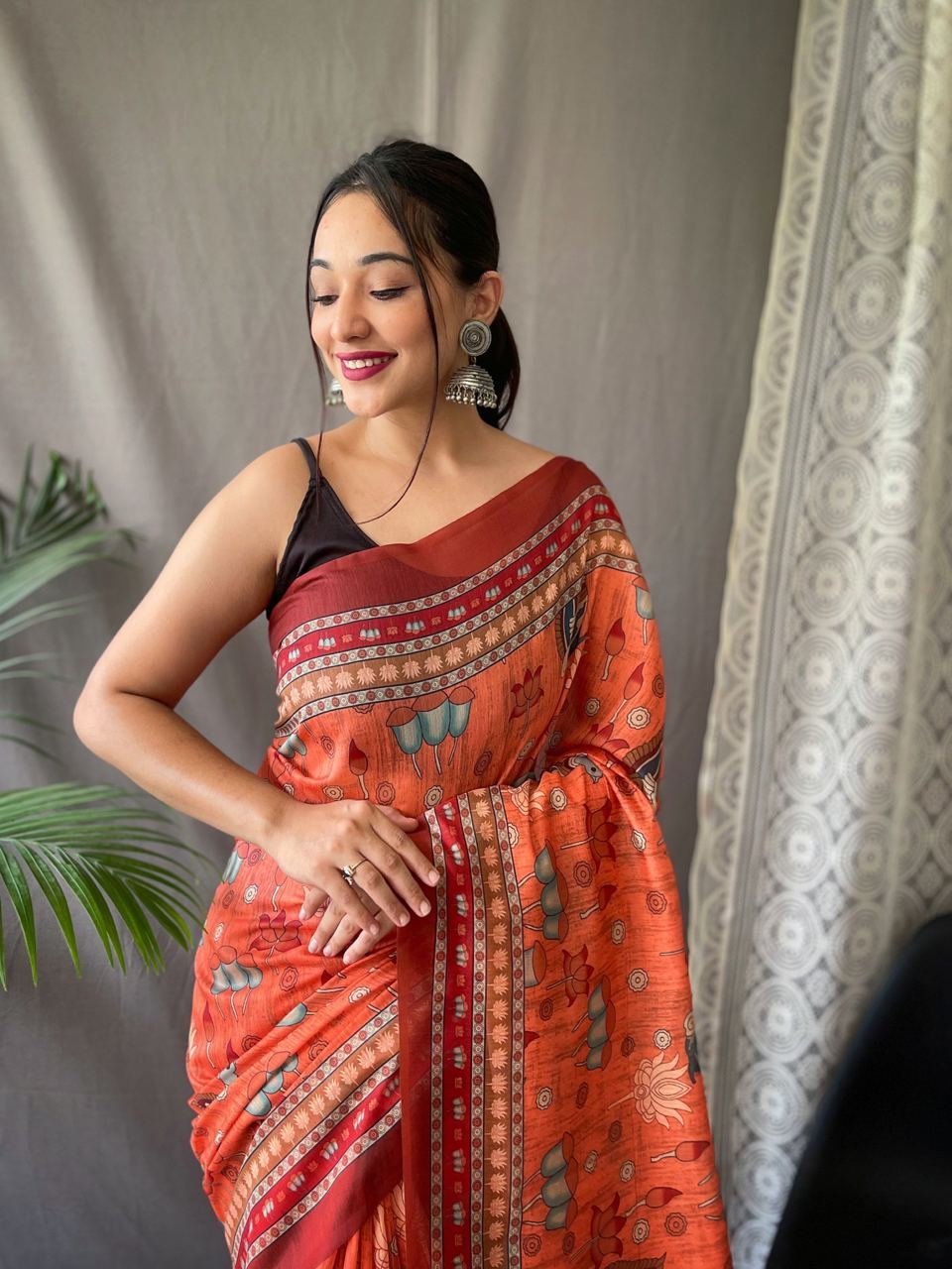 Women’s Artistic Terracotta Orange Linen Saree with Kalamkari Inspired Print & Tassel Detailing – Perfect for Casual Festivities & Cultural Events